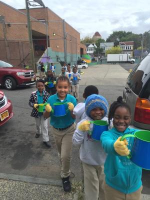 Students carry 30 watering cans down 3 stories to grow our garden. 